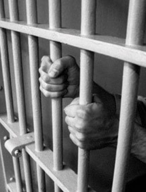hands holding prison bars