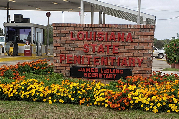 Sign outside of Louisiana State Penitentiary surrounded by flowers