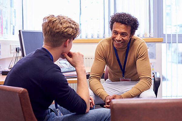 Two people talking in a small office