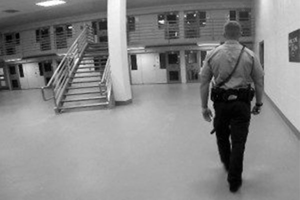 Guard walking through jail
