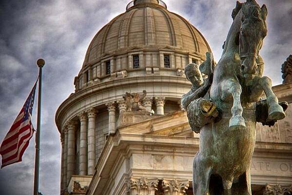 Oklahoma state capitol and statue of man riding a bucking horse